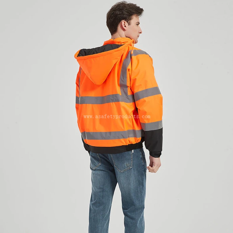 model wearing hi vis orange hooded safety jacket on construction site model wearing hi vis orange hooded safety jacket on construction site