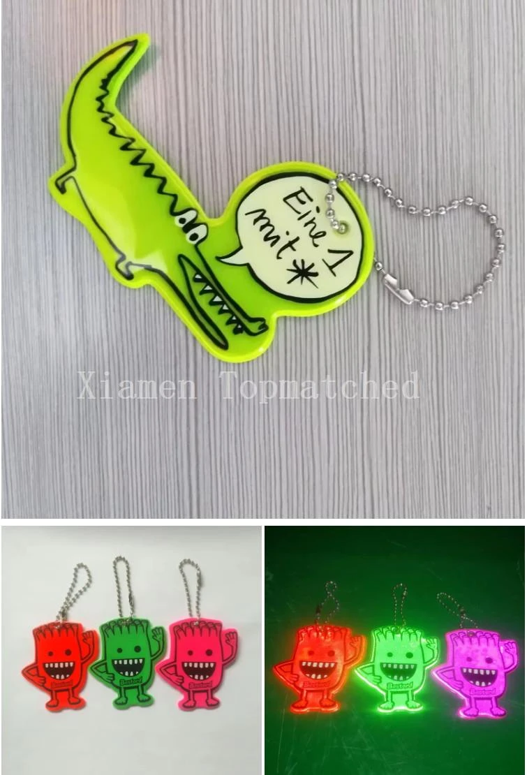 Custom die-cut soft PVC reflective keychains showing green crocodile design and night headlight reflectivity test Custom die-cut soft PVC reflective keychains showing green crocodile design and night headlight reflectivity test