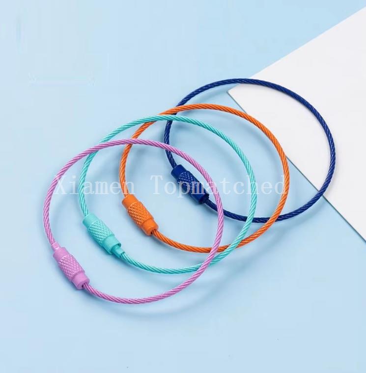 Assorted colorful nylon coated aircraft cable key rings held in hand wholesale Assorted colorful nylon coated aircraft cable key rings held in hand wholesale