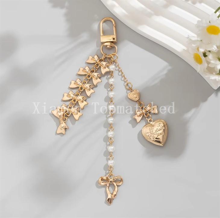 gold-alloy-bowknot-and-pearl-bag-charm